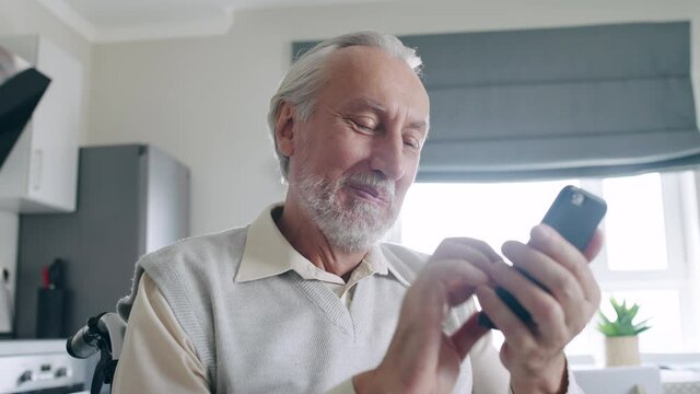 Cheerful pensioner typing message in smartphone, modern technology, application