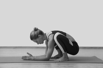 Young woman yoga teacher in studio