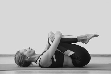 Young woman yoga teacher in studio