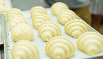 Fresh France plane croissant on bakery restaurant cafe coffee wooden table.restaurant bakery menu.dessert.bakery shop, baked croissant.Homemade croissants on bakery cafe.Dessert breakfast in France.