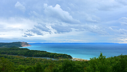 a stunning view across the turquoise colored water of lake michigan and sand dunes from the north...