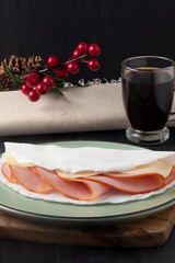 Brazilian northeast snack tapioca of ham and cheese served with coffee.