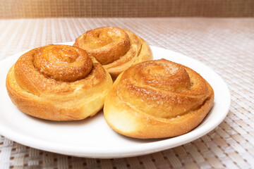 buns on a white plate on the table.