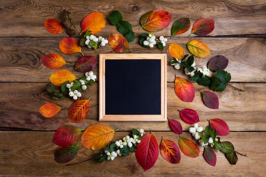 Square wooden frame mockup with fall leaves