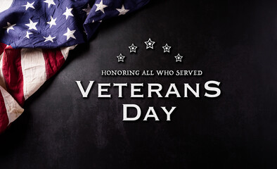 Fototapeta na wymiar Happy Veterans Day concept. Vintage american flags against black stone background. November 11.