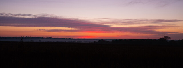 beautiful morning sky sunrise on the autumn field.