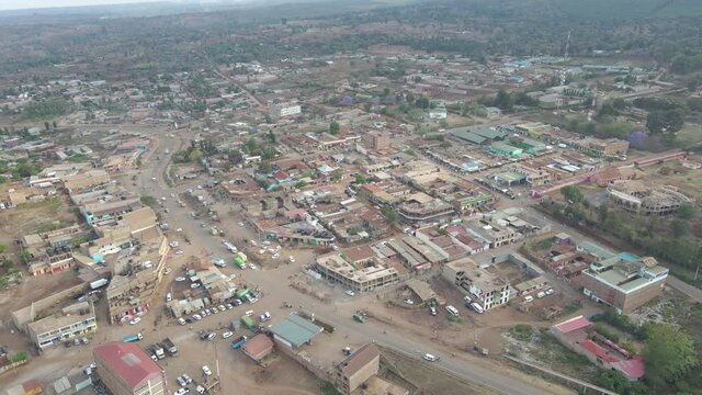 Sunset in the small village. An evening in the small village of Africa. Aerial view following a truck driving through a small town, in rural Africa - top down, drone shot