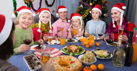 Happy family is talking at the table in time celebration New Year at home
