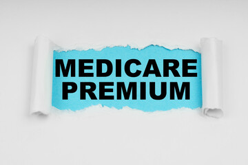 In the middle of a white sheet in space on a blue background the inscription - MEDICARE PREMIUM