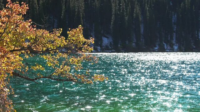 Mountain lake. Autumn Landscape is a stock video that shows wonderful pictures of a mountain lake sparkling under the rays of the autumn sun.