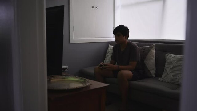 Young Boy Playing Video Games During the Day Wide Shot