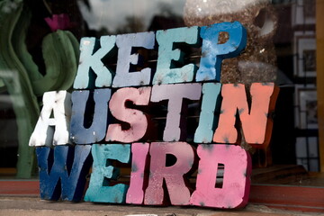 Colorful plate with word Austin in front of a shop window