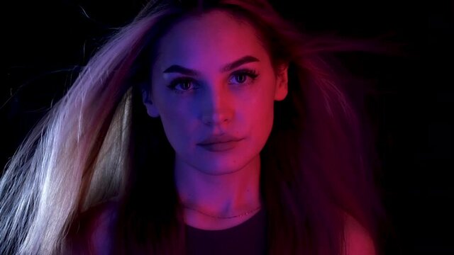 Blowing hair Portrait woman move colorful neon led light. Glamour face fashion ultraviolet illuminance. Luxury motion hair wind air girl led lighting. Style blow colors neon illumination ultra violet.