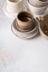 Set of ceramic tableware. Empty craft ceramic plates, bowls, and cups.