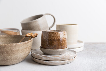 Set of ceramic tableware. Empty craft ceramic plates, bowls, and cups.
