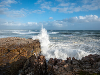 Large ocean swells crashing into rocky shoreline at Siever's Point. Hermanus. Whale Coast. Overberg. Western Cape. South Africa