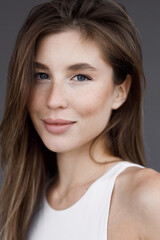 Fototapeta premium Portrait of a young beautiful girl in close-up. Natural clean skin and natural makeup.