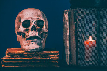Still life of  skull, old books and lantern. Horror halloween theme