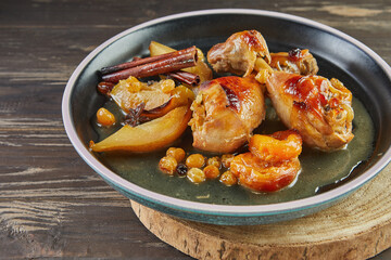 Chicken legs with honey, raisins, apples and pears caramelized. French gourmet cuisine