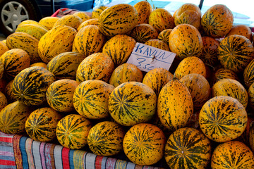 Ripe melons on display at the farmer's market outdoors on summer day. Healthy eating concept