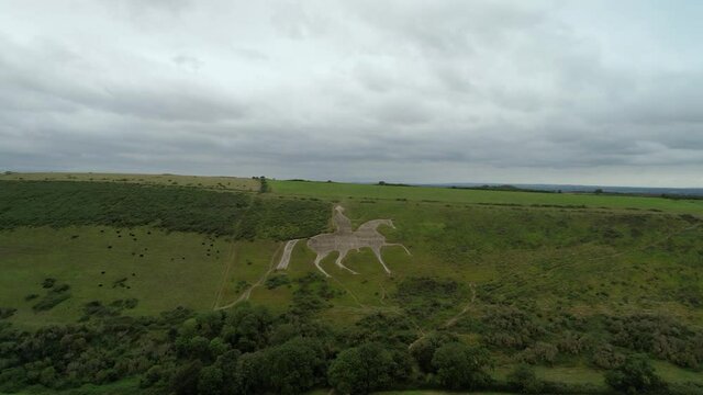 Osmington White Horse legendary chalk figure art on hillside slope aerial view rising above countryside