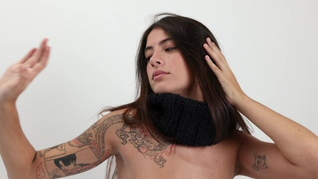 Woman posing and dancing in knitwear scarf