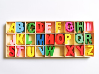 Concept of back to school and education. Colorful wooden alphabet letter set in box.