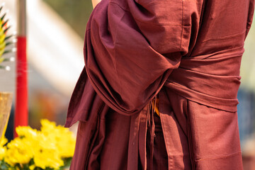 Close up Asian Monk wears red brown cloth for Northern Thailand Traditional Event.
