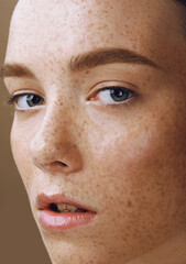 Close up portrait of young with perfect shining skin and freckles