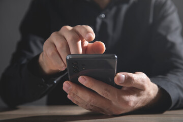 Caucasian businessman using smartphone in office.