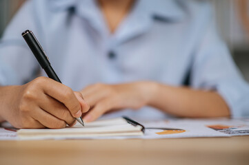 Young woman working with paperwork at home