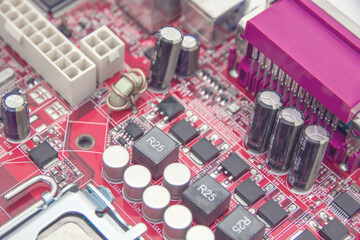 Background of the close up photo of red printed circuit board with dip components. LED diods, resistors, capasitors and processor
