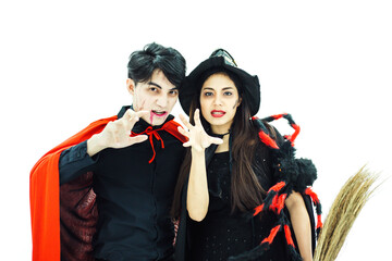 Two Asian friends wearing Halloween costume as Dracula and witch acting scary isolated on white background.