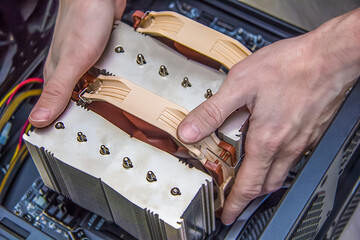 Assembling a personal desktop computer. Installing the cooler, radiator, air cooling system for the...