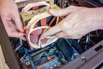 Assembling a personal desktop computer. Installing the cooler, radiator, air cooling system for the...