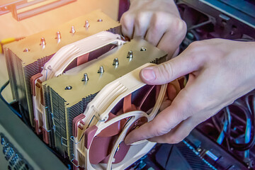 Assembling a personal desktop computer. Installing the cooler, radiator, air cooling system for the...