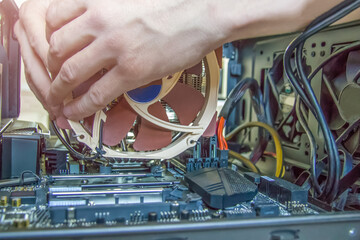 Assembling a personal desktop computer. Installing the cooler, radiator, air cooling system for the...