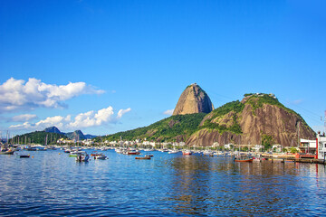 Berth, port with boats, shallops and Urku mountains and Sugar Loaf. Guanabara Bay, a creek on the shores of the Atlantic Ocean. Brasilia, Rio de Janeiro