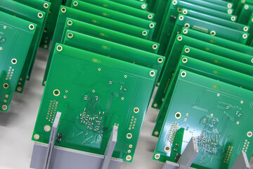 Production and assembly of pcb and chips in a factory. Boards are in a row.