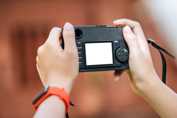Female photographer is holding a camera