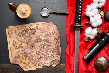Samurai sword and ancient map on the old flat lay table concept background.
