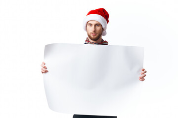 handsome man in a christmas hat with white mockup poster christmas light background