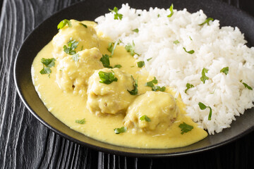 Meatballs in Curry Sauce with rice close up in the plate on the table. horizontal