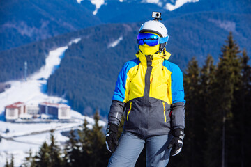 woman in ski equipment on the top of the hill