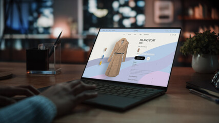 Close Up on Hands of a Female Using Laptop Computer with Clothing Online Web Store to Choose and...