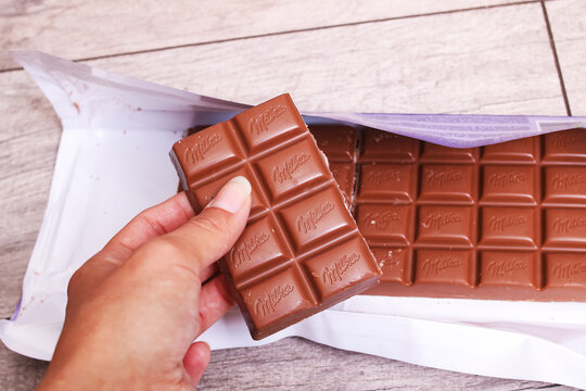 BELARUS, NOVOPOLOTSK - 20 OCTOBER, 2021: Big Milka chocolate bar on wooden table