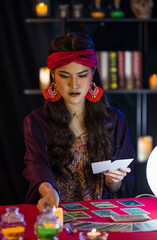 Asian witch with tarot cards