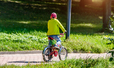 boy ride on the bike path in the city Park
