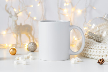 Obraz na płótnie Canvas White ceramic tea mug mockup with winter xmas decorations and copy space for your design. Front view 10oz cup background for Christmas promotional content.
