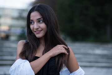 Portrait of a beautiful, happy and attractive Caucasian or Arabian brunette girl dressed in casual style.